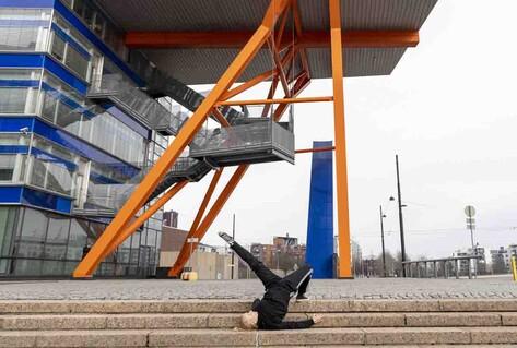 Breakdancer posing in construction site