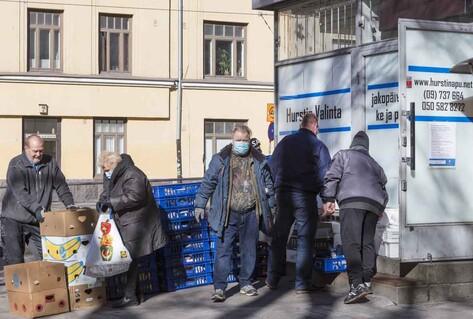 Disadvantaged people collecting food from truck