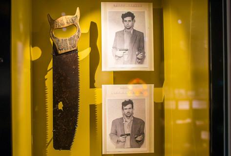 Showcase in 1940s section with saw and posters