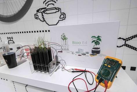 Square device plugged into plant, to charge mobile phones