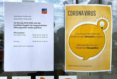 Two posters outside post office listing new measures