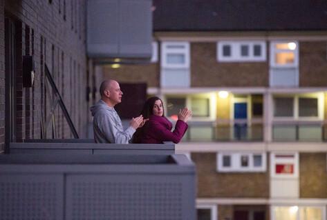 Man and woman outside flat clapping