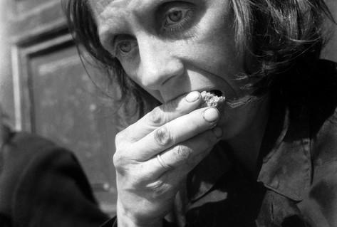 Black white photograph starving woman eating