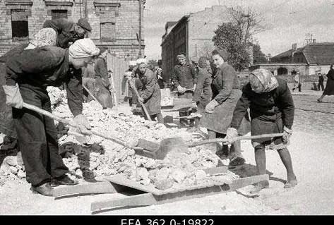 Black white photograph women clearing rubble