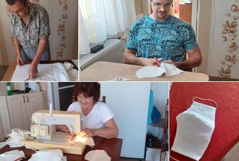 Family sewing masks in stages