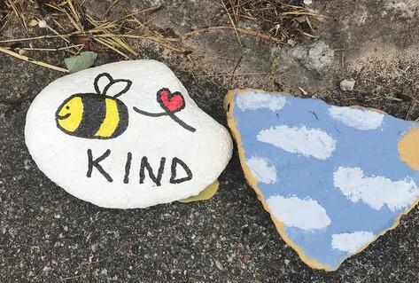 painted pebbles with kindness message