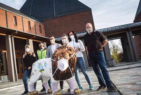 Family and lifesize lion in masks