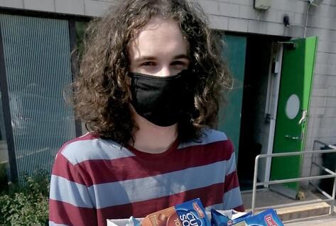Young man holding food box
