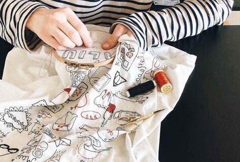 Person doing embroidery on cloth