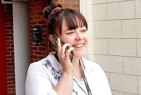 Woman on phone in front of building