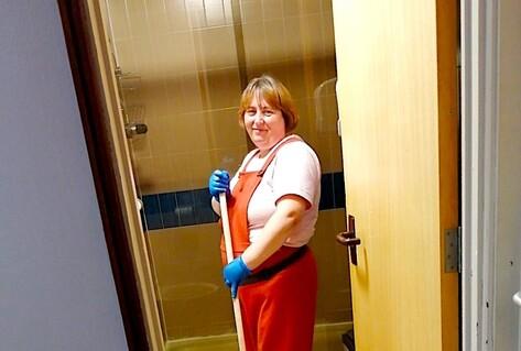 Woman standing with mop