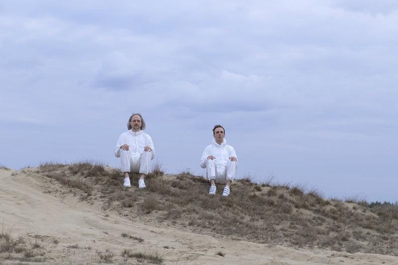 Musicians in white on hill