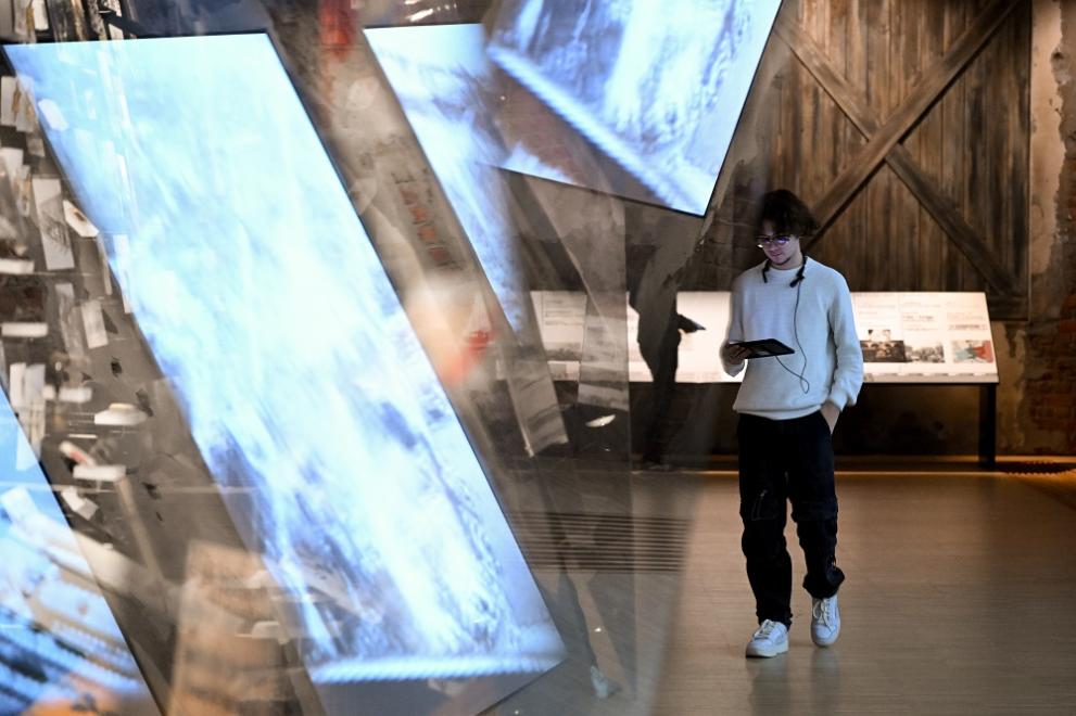 Visitor walking past Shoah display