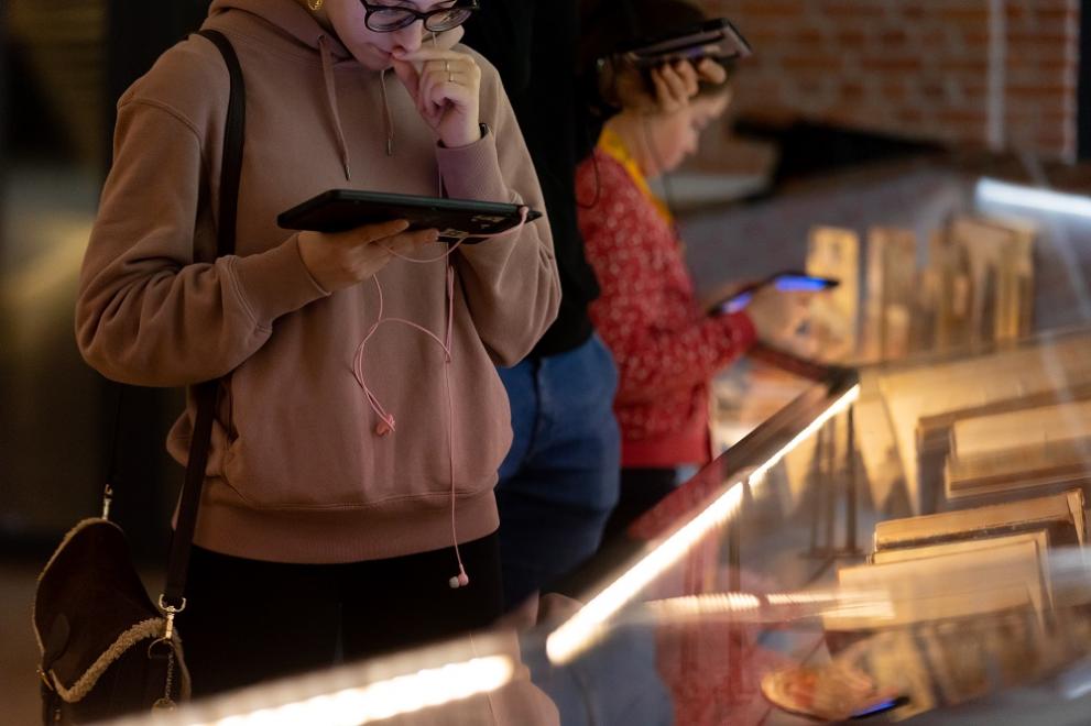 Visitor using tablet in front of display