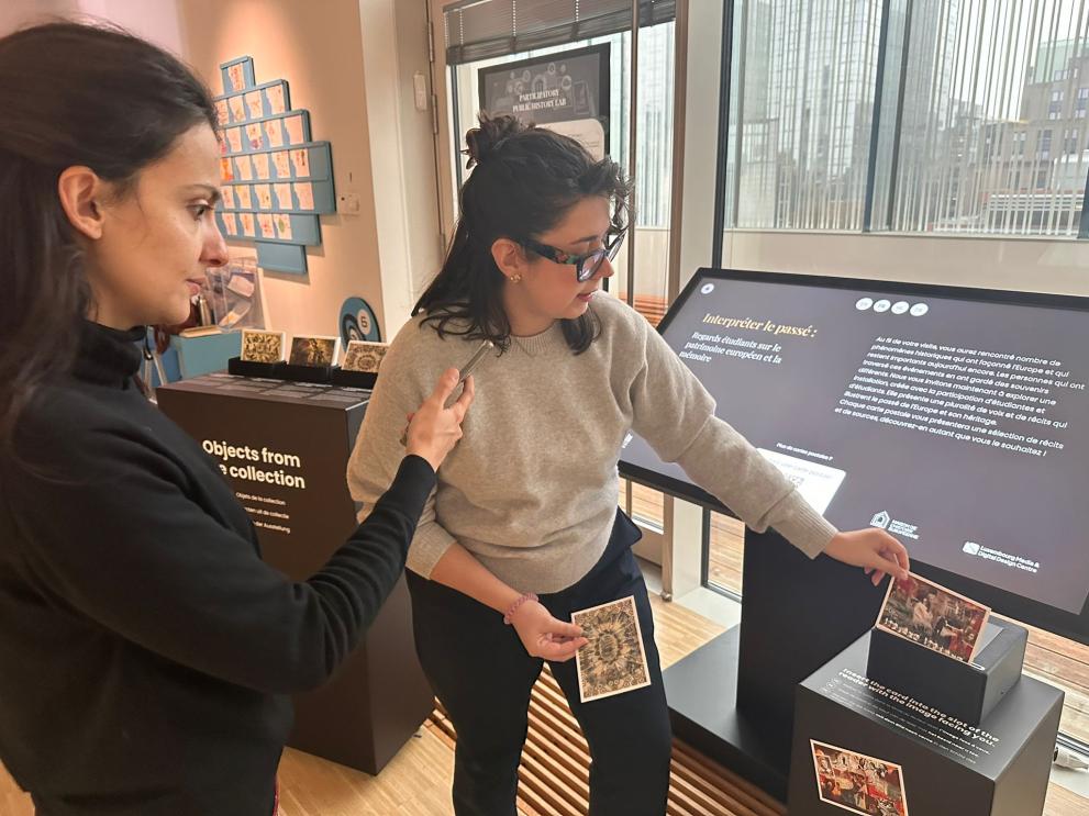 Woman showing postcards in museum