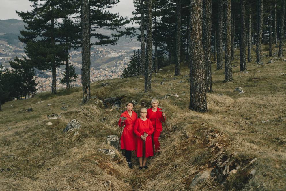 A grandmother, mother and daughter prepare to plant flowers in the former trenches from which Sarajevo was besieged between 1992 and 1996