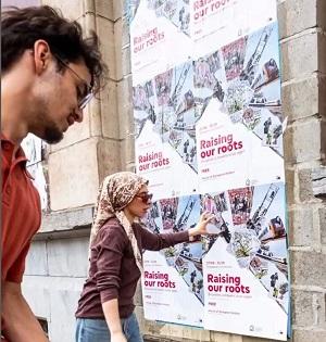 Man and woman putting up posters