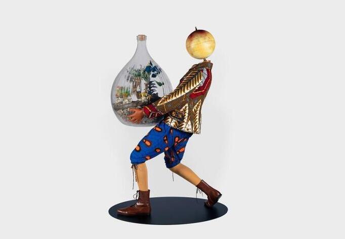 Boy in colourful clothes holding glass ball