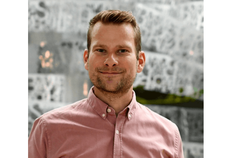Man in front of vortex in museum