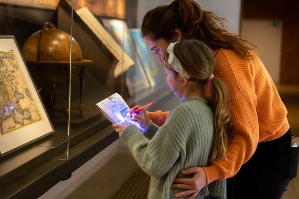 Woman and child looking at display case